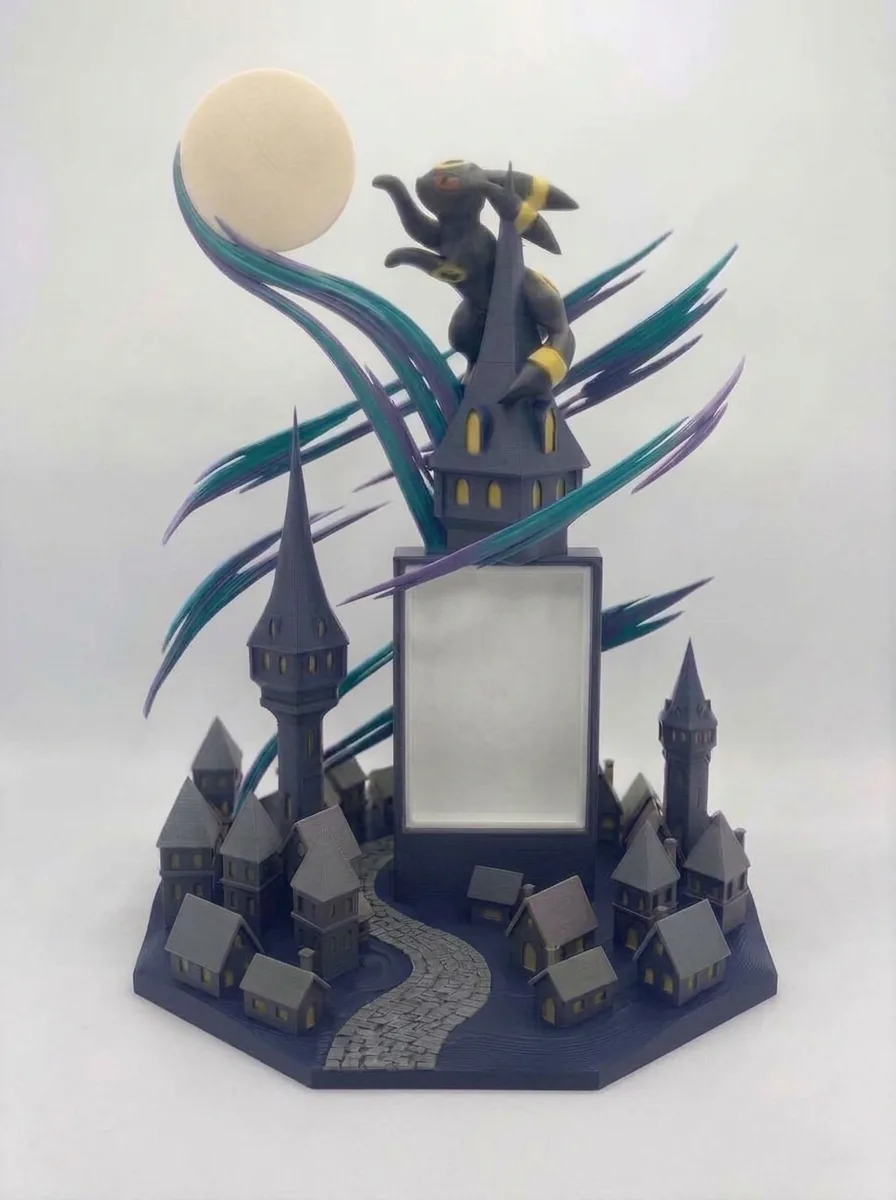 Umbreon on a tower above a moonlit town, with a card window in the tower